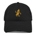 Gorra negra Doozy Headwear tipo distressed con dibujo de banana animada en el frente.
